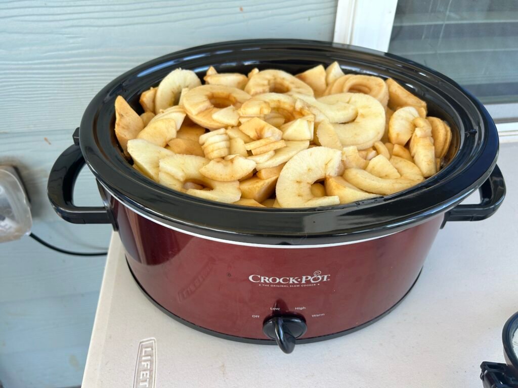 spiral cut apples in a black crock pot