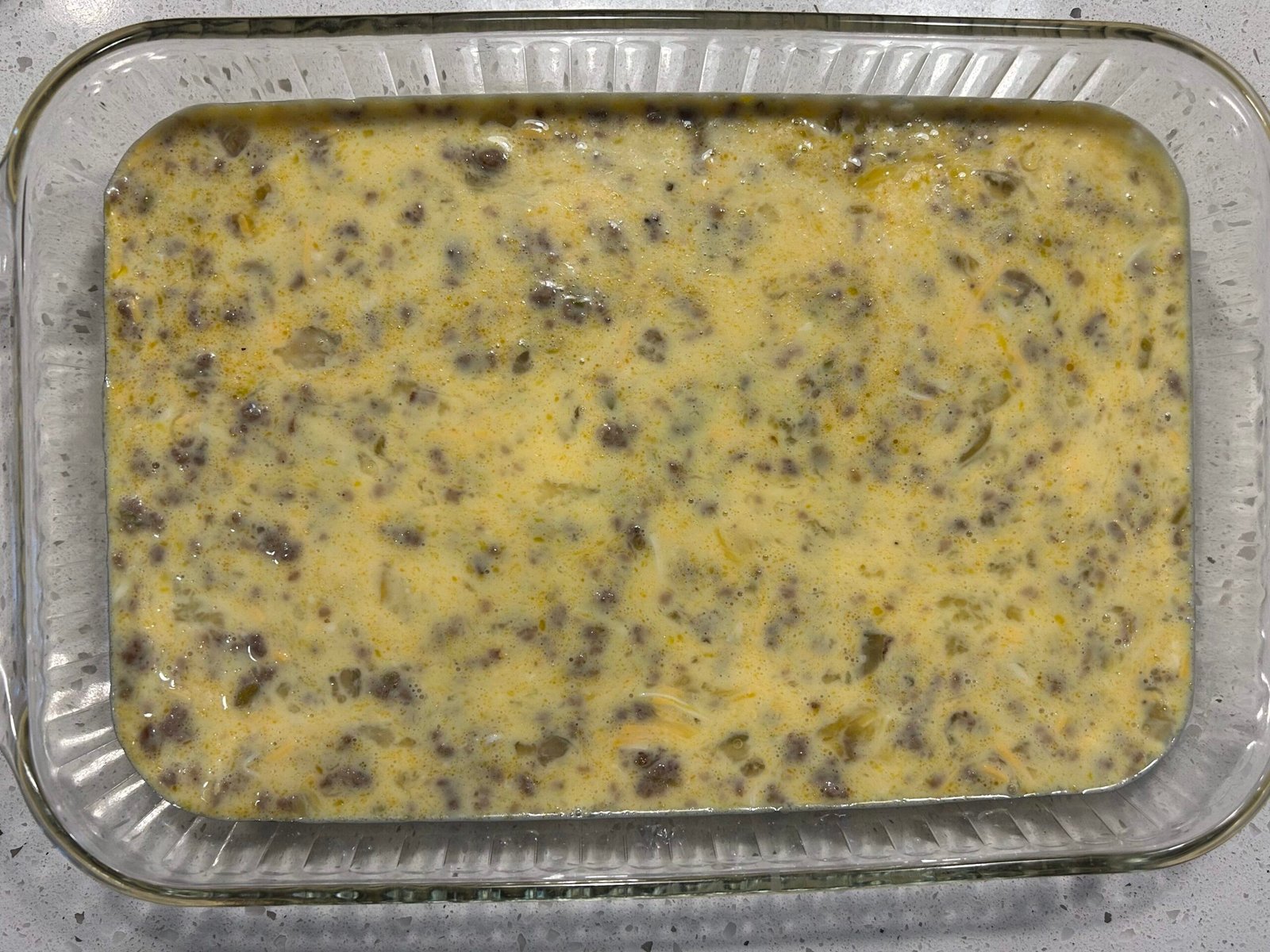 Uncooked egg bake in a glass 9x13 baking dish.