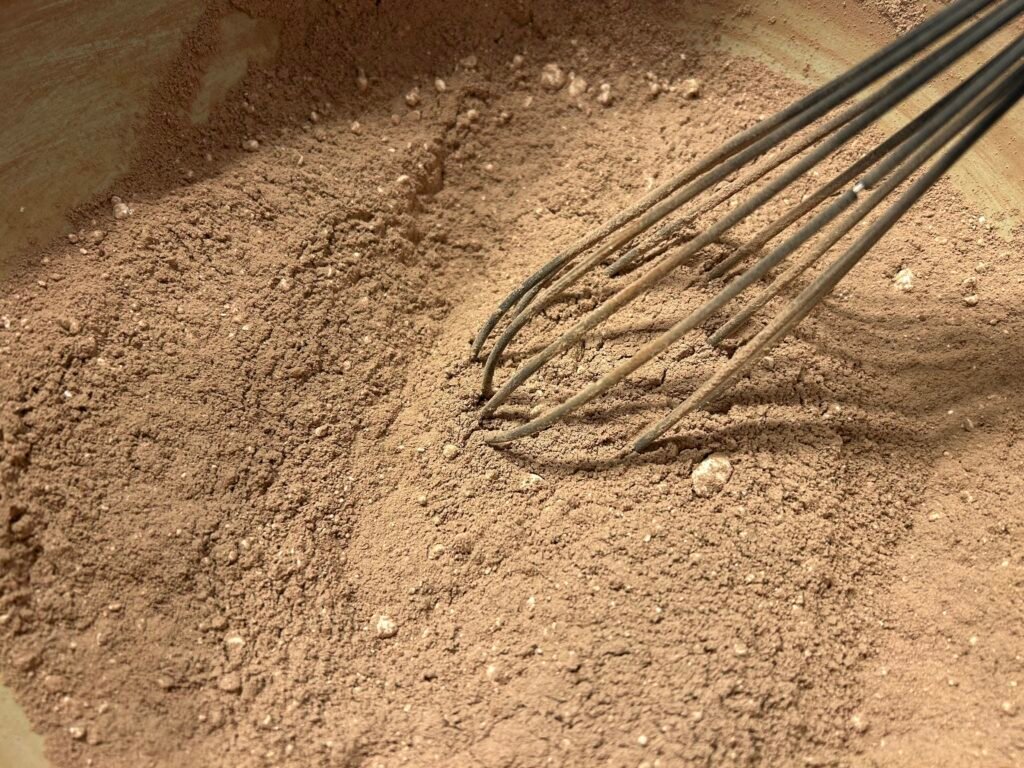 Whisk in a blue bowl whisking cocoa mix
