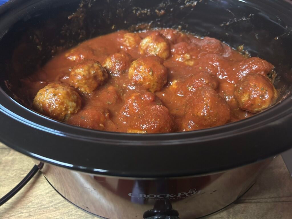 pasta sauce cover meatballs in a crockpot